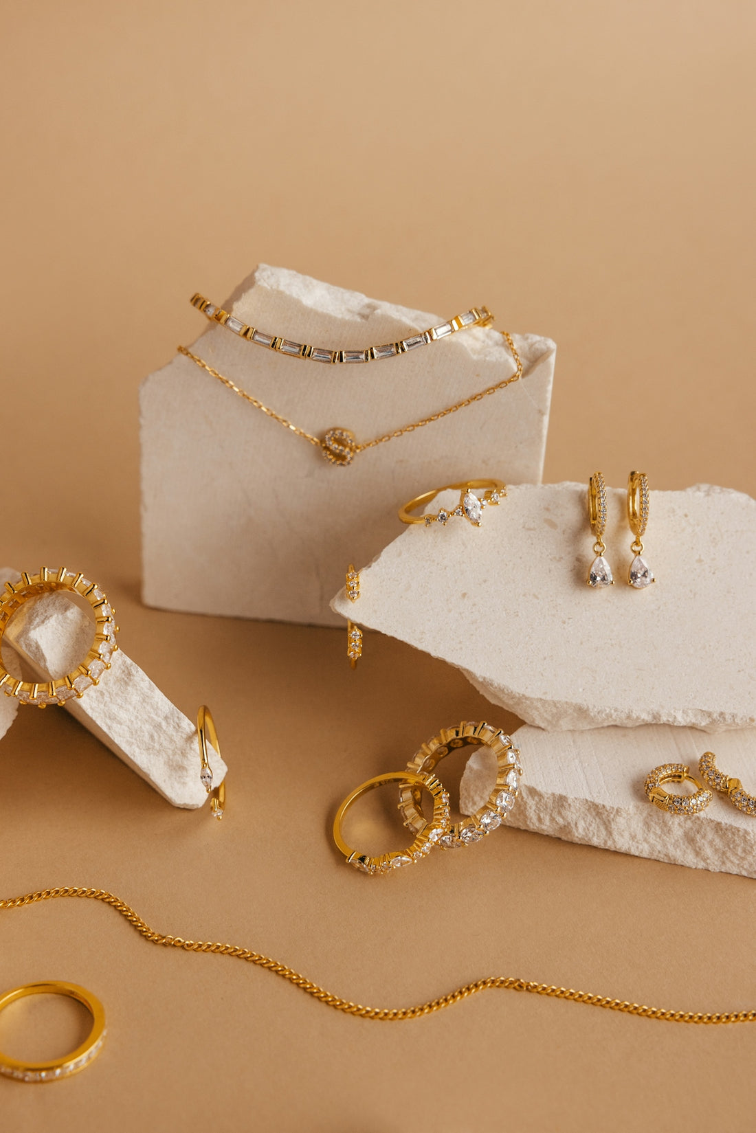a white box with gold jewelry on it